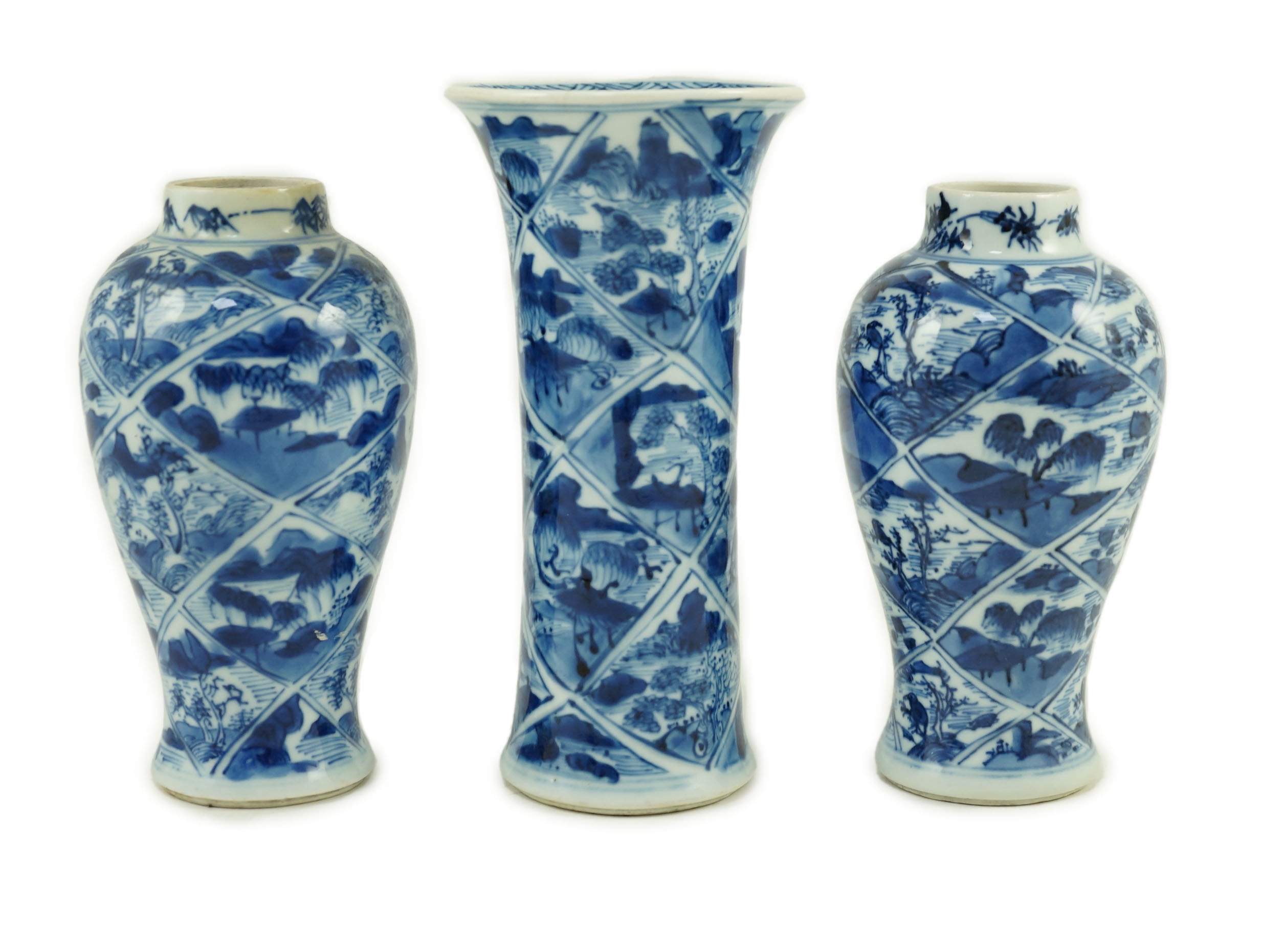 A garniture of three Chinese blue and white vases, Kangxi period, 13 cm and 15 cm high, one rim restored